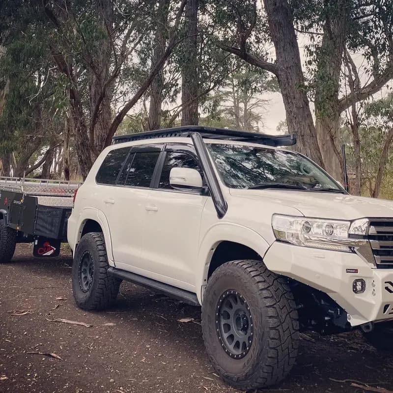 A 200 Series hitched to a camper trailer under the gums.